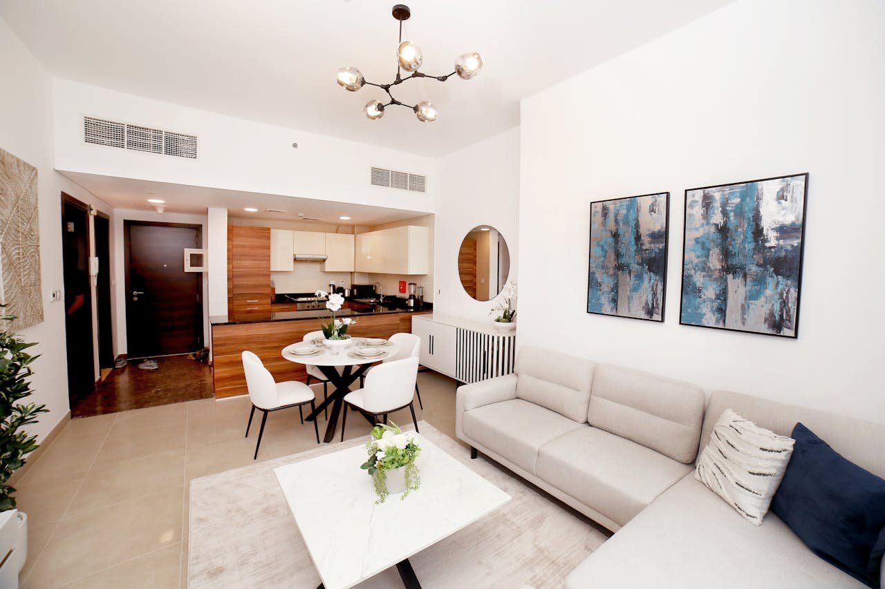 gallery-02 Contemporary living room with an open kitchen, modern decor, and cozy ambiance.